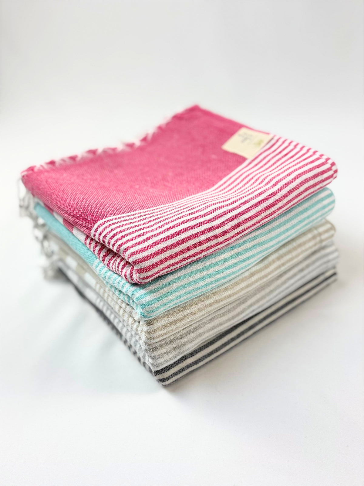 A stack of folded Turkish cotton towels showing the woven texture